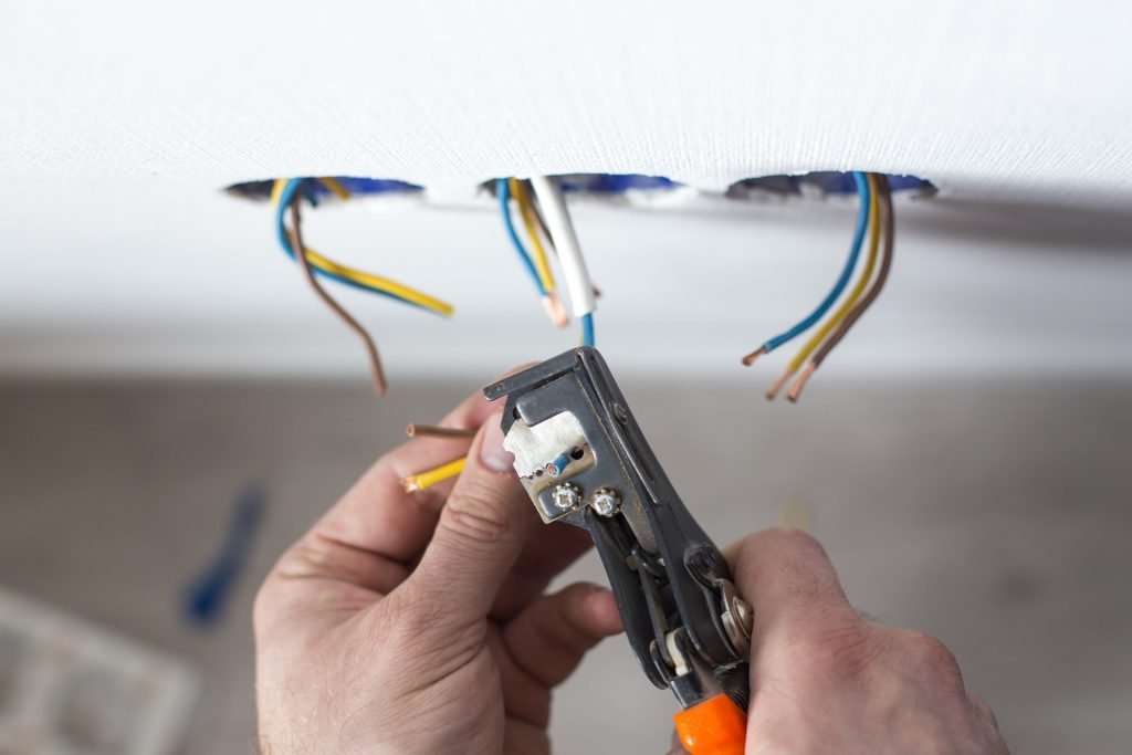 Electrician stripping wires