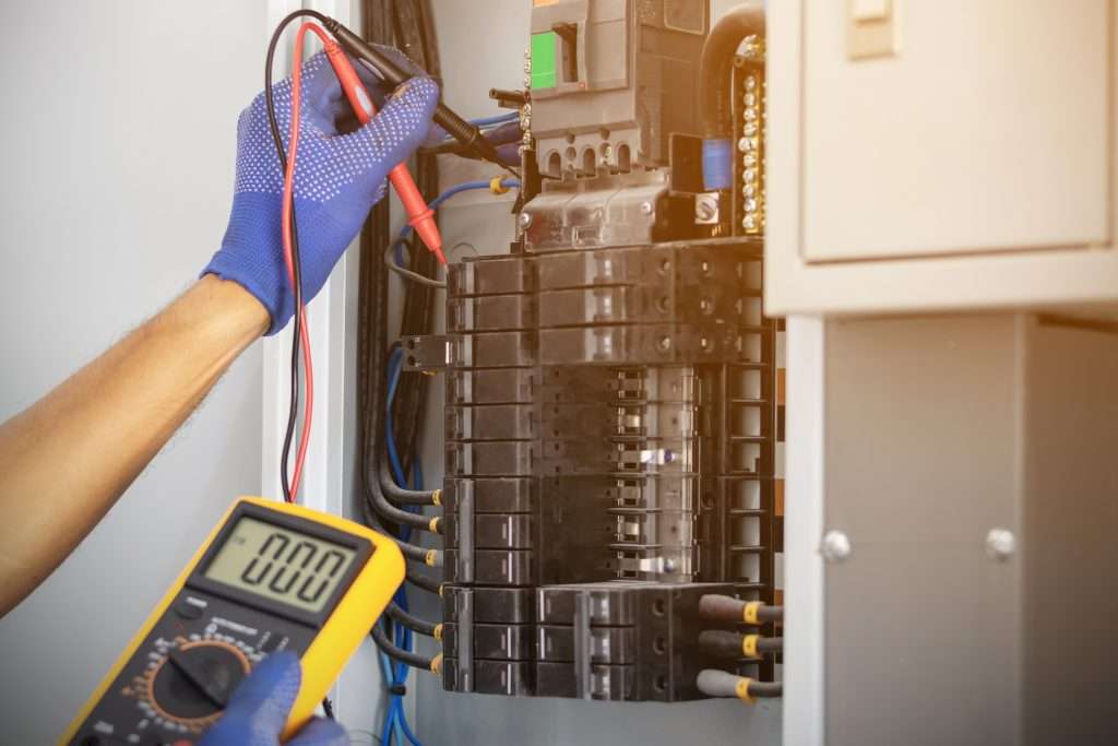 Electrician working on breaker box